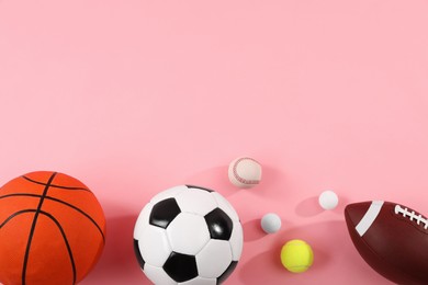 Photo of Many different sports balls on pink background, flat lay. Space for text