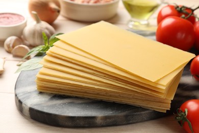 Photo of Ingredients for lasagna on white wooden table, closeup
