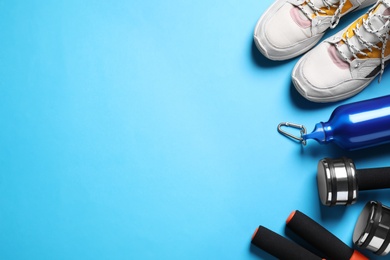 Photo of Flat lay composition with sport items on blue background. Space for text