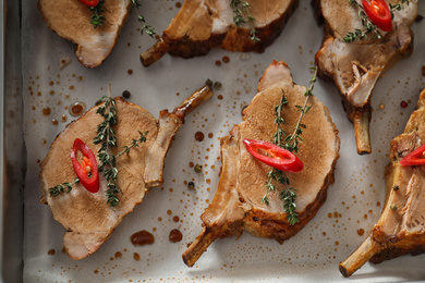 Delicious roasted ribs in baking tray, flat lay