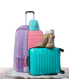 Photo of Suitcase with warm clothes isolated on white. Winter vacation