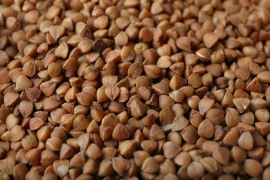 Photo of Uncooked buckwheat as background, closeup. Organic wholesome product