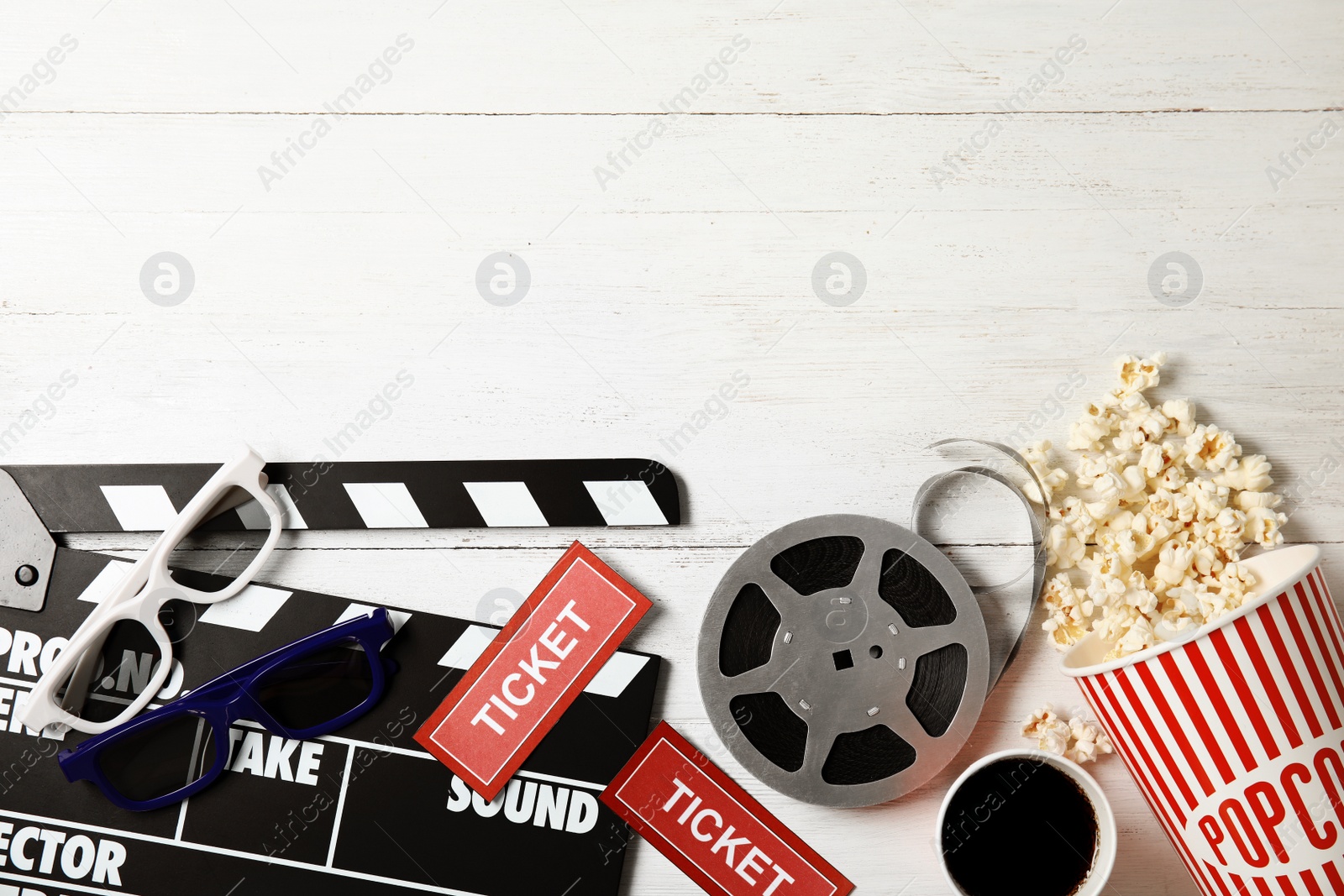 Photo of Flat lay composition with clapper, popcorn and space for text on wooden background. Cinema snack