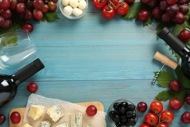 Frame of tasty red wine and snacks on light blue wooden table, flat lay. Space for text