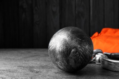Photo of Prisoner ball with chain on grey table, space for text