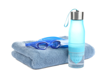 Photo of Swimming cap, goggles, water bottle and towel isolated on white