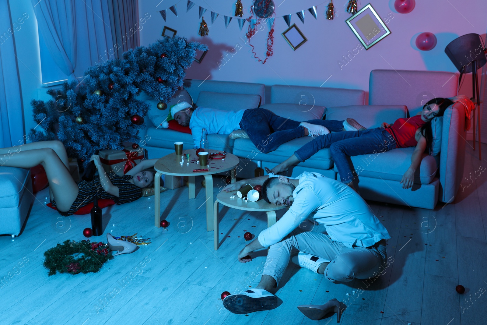 Photo of Drunk friends sleeping in messy room after New Year party