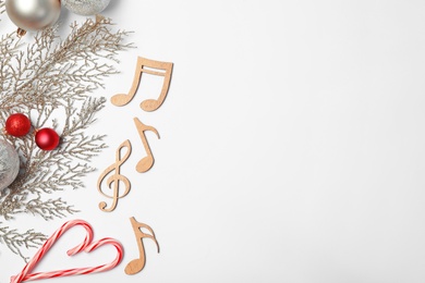 Composition with wooden music notes and space for text on white background, top view