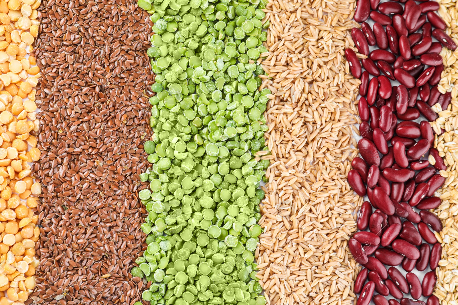 Photo of Different grains and cereals as background, top view