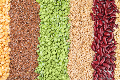 Photo of Different grains and cereals as background, top view