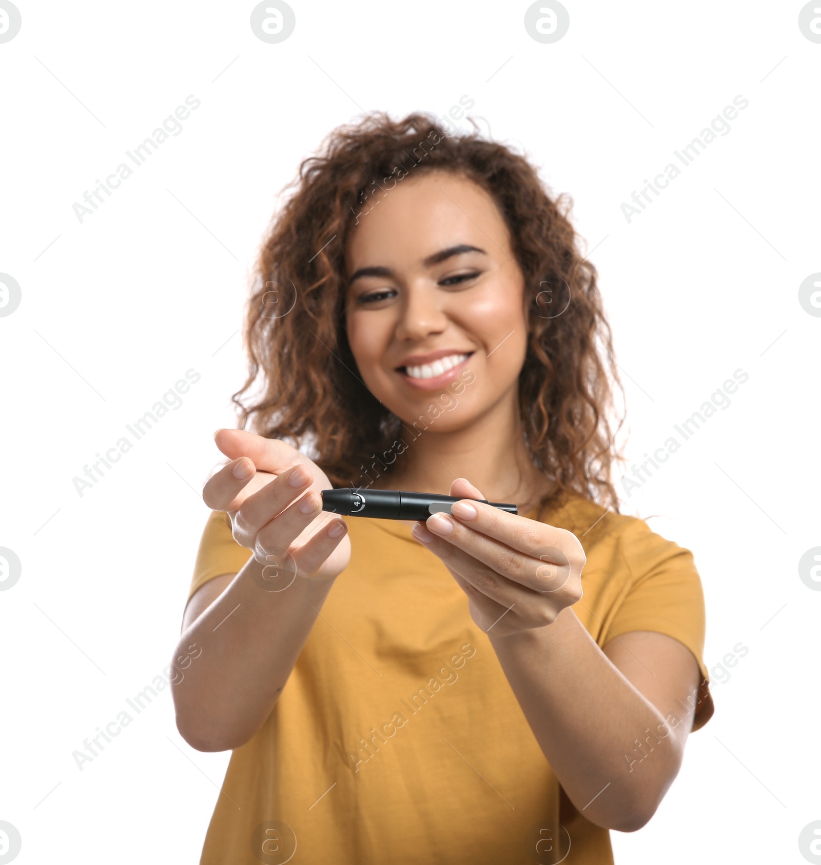 Photo of Young African-American woman using lancet pen on white background. Diabetes control