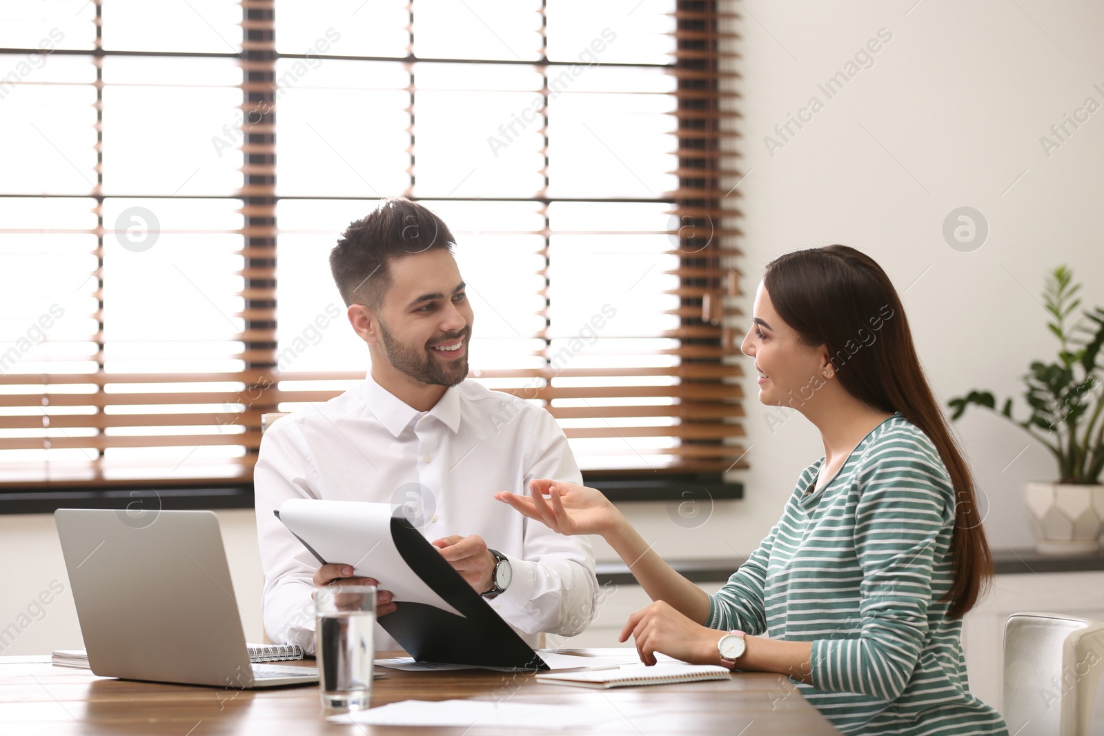 Photo of Insurance agent consulting young woman in office