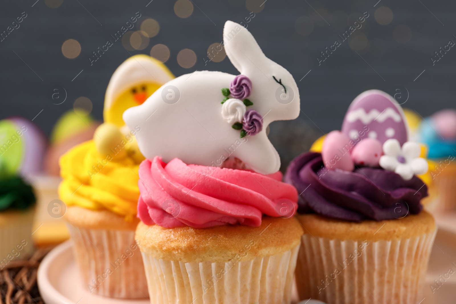 Photo of Tasty decorated Easter cupcakes on table, closeup