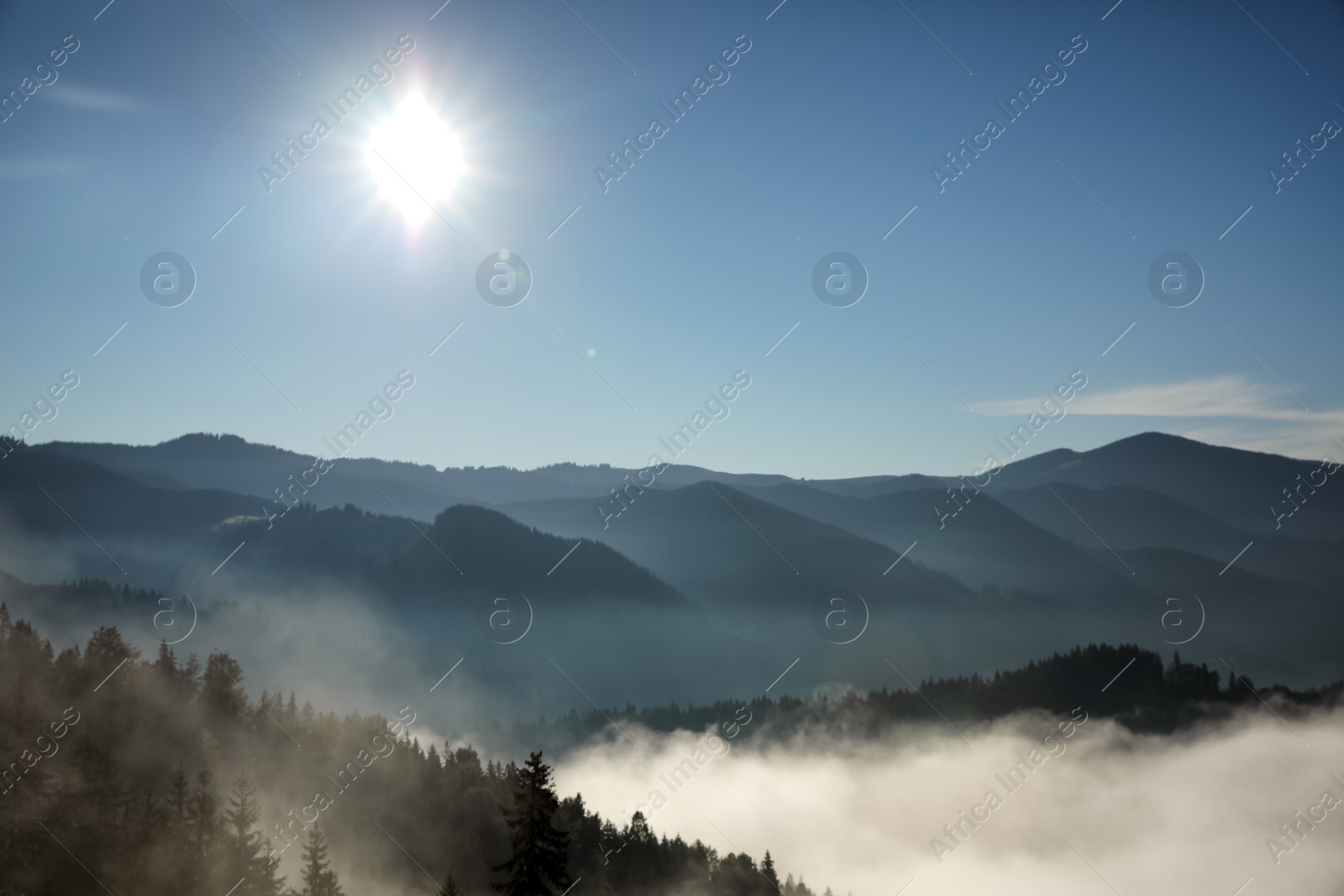 Photo of Beautiful view of mountains covered with fog at sunrise