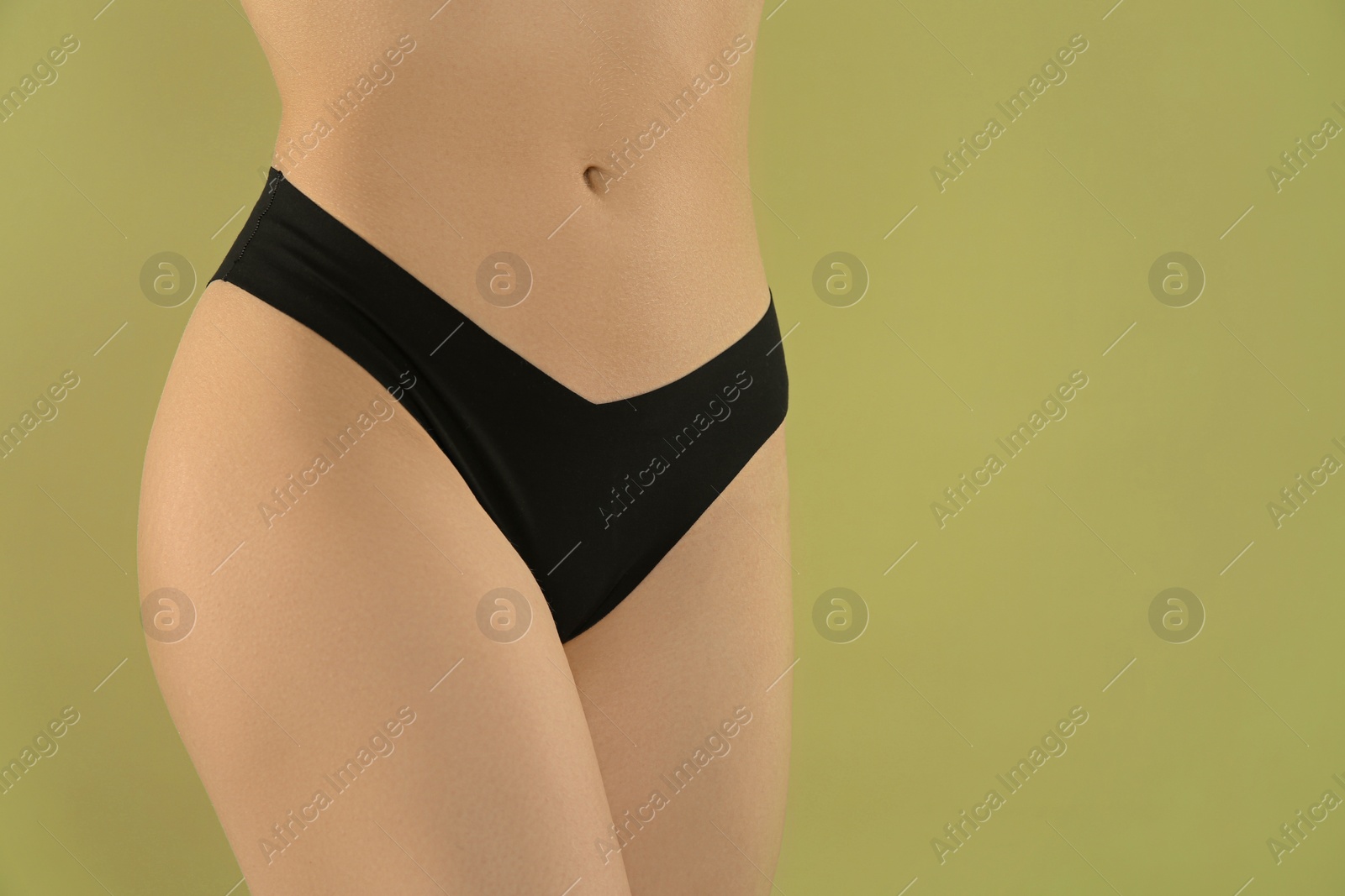 Photo of Gynecology. Woman in underwear on green background, closeup. Space for text