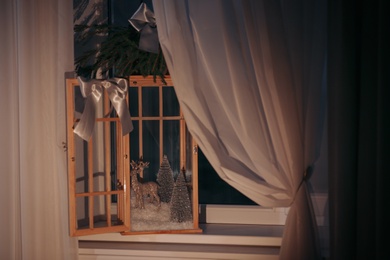 Photo of Vintage wooden lantern with beautiful Christmas composition on window sill indoors