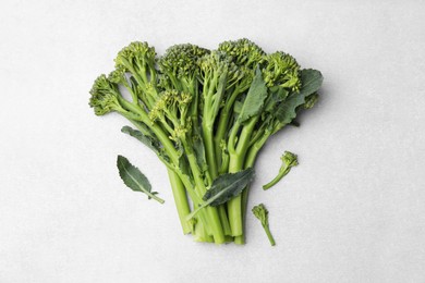 Photo of Fresh raw broccolini on white background, flat lay. Healthy food