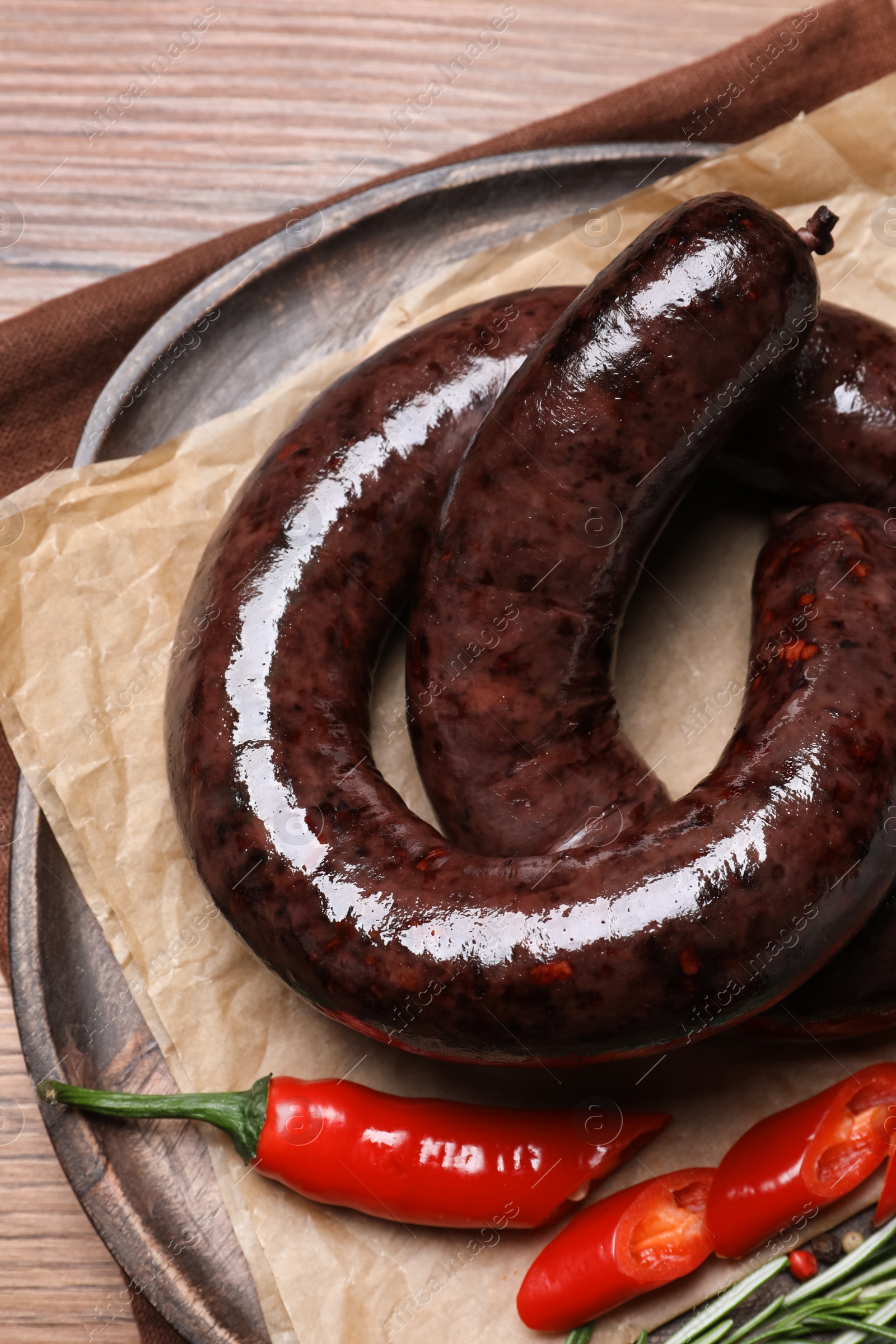 Photo of Tasty blood sausages served on wooden, top view