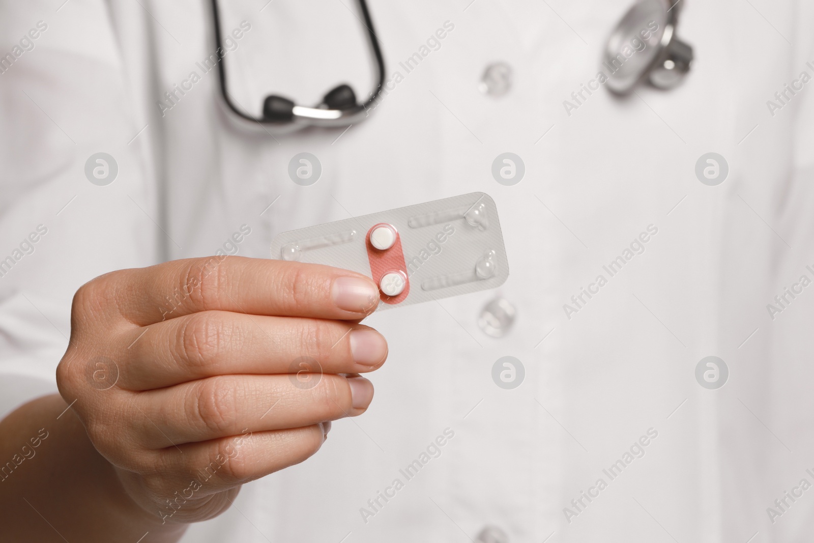 Photo of Doctor holding blister of emergency contraception pills, focus on hand