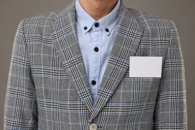 Photo of Man with blank badge on grey background, closeup