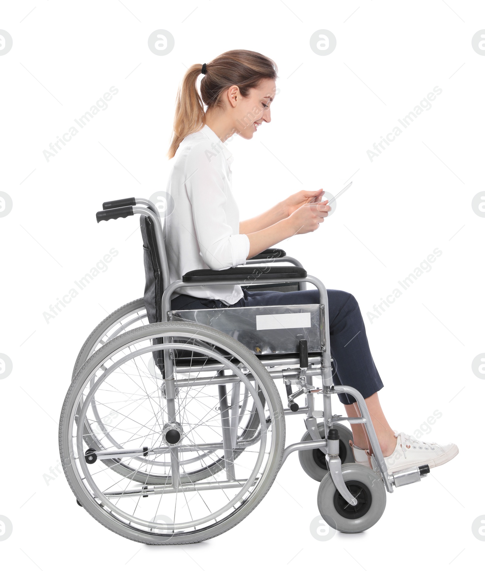 Photo of Young woman in wheelchair using tablet isolated on white