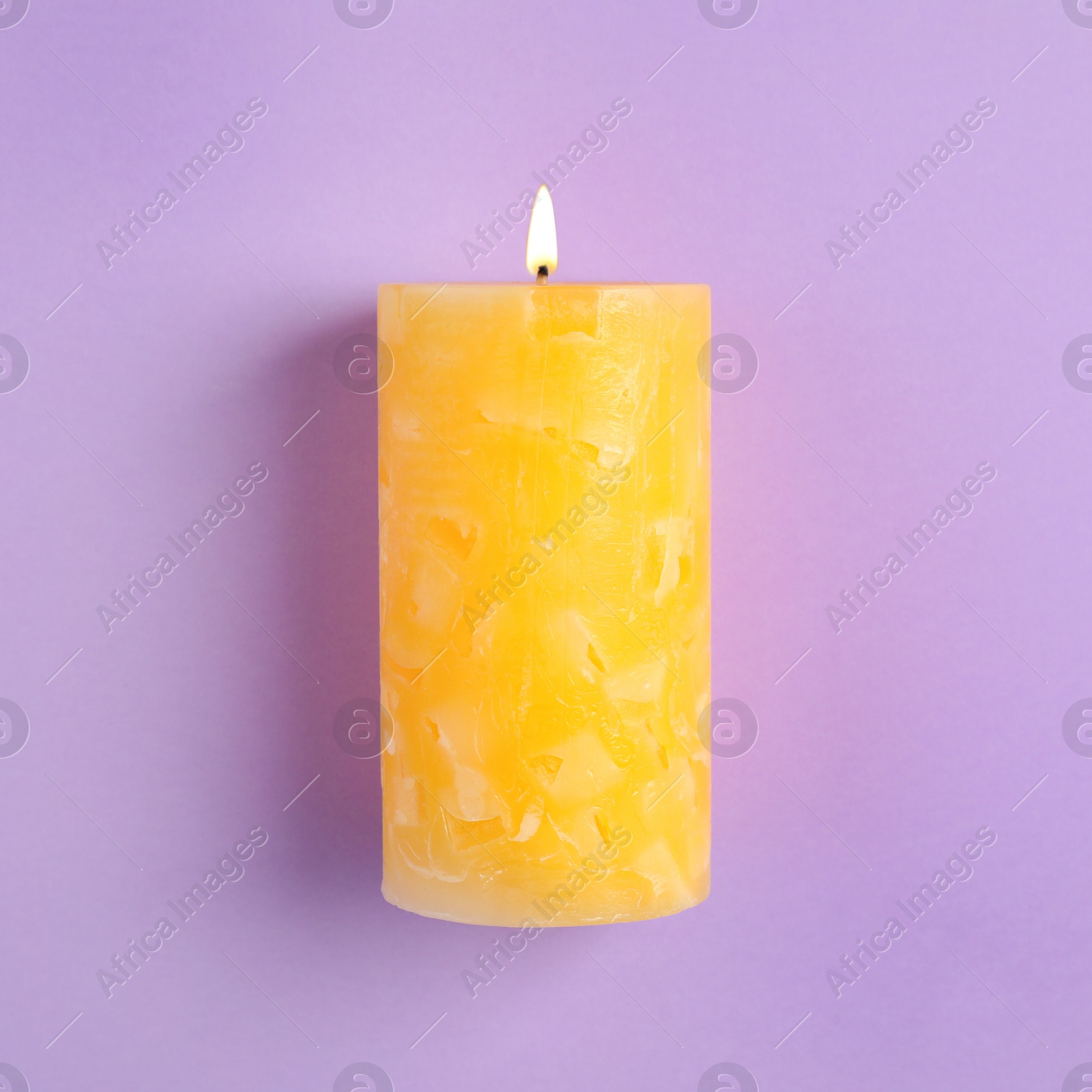 Photo of Alight scented wax candle on color background