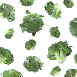 Image of Set of fresh green broccoli falling on white background