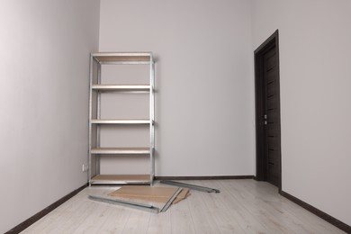 Office room with white walls and metal storage shelf