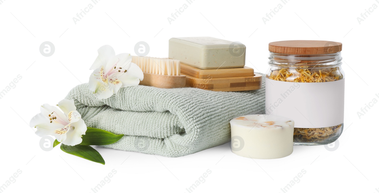 Photo of Spa composition. Towel, personal care products, brush, fresh and dry flowers on white background