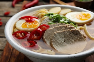 Delicious ramen in bowl on table, closeup. Noodle soup