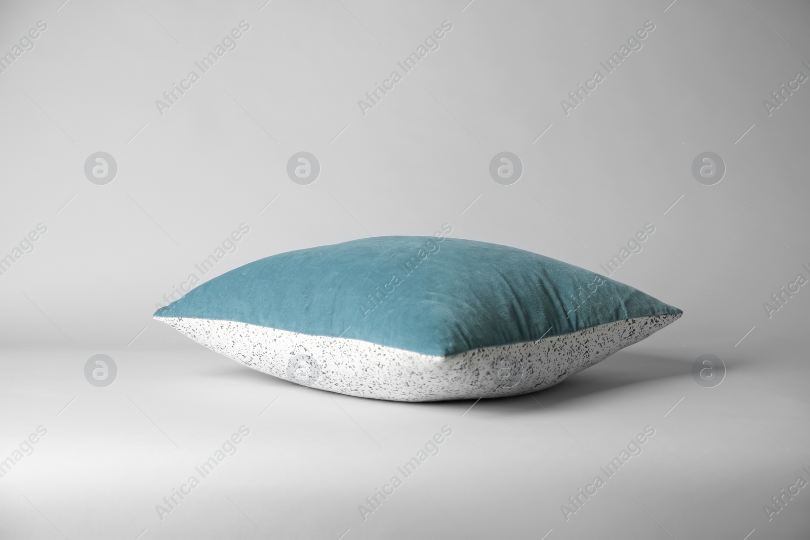 Photo of Soft decorative pillow on light background