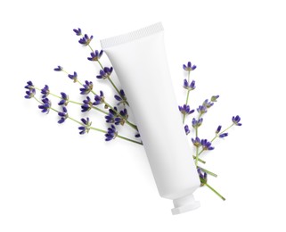 Tube of hand cream and lavender on white background, top view