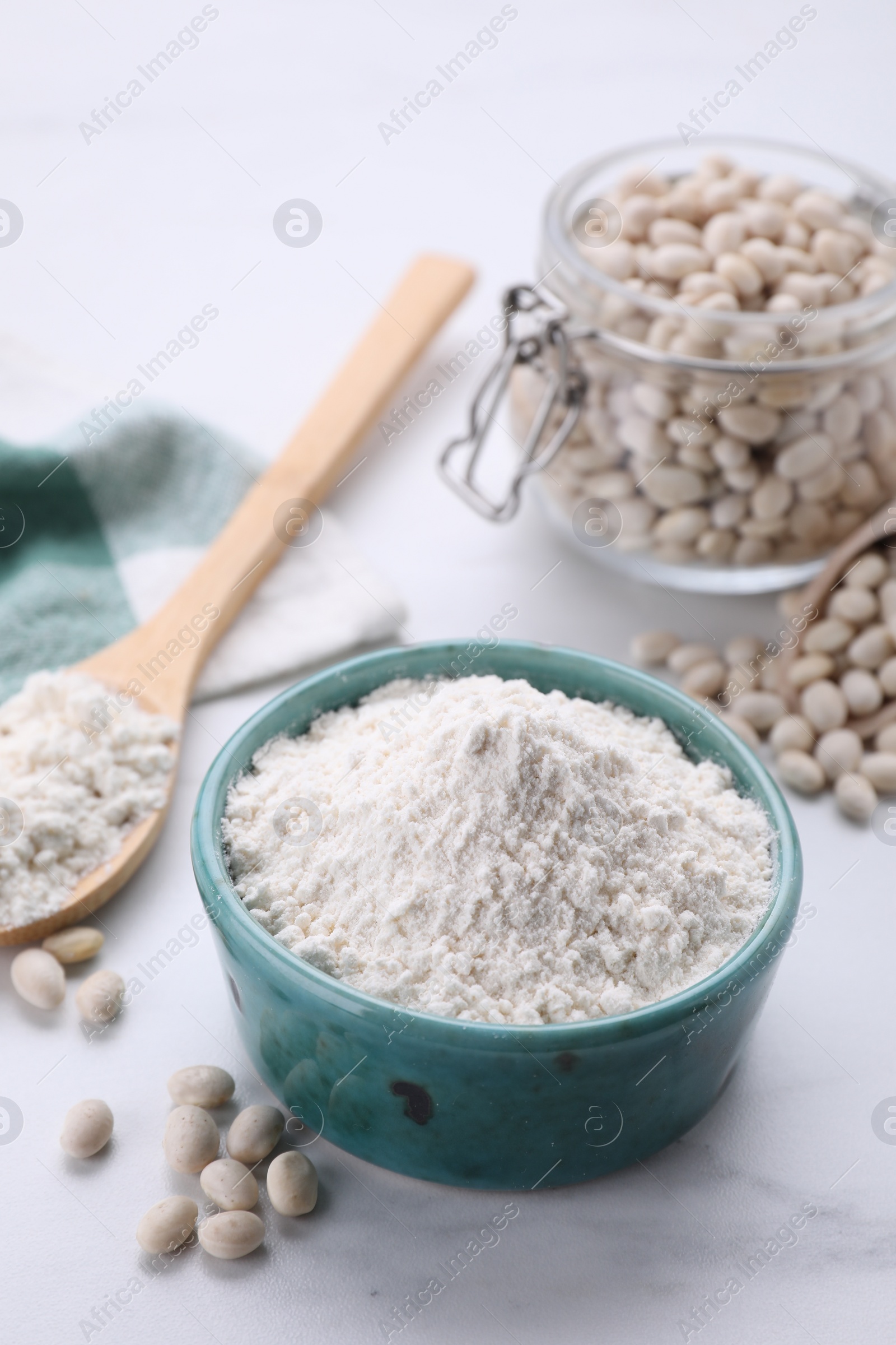 Photo of Bean flour and seeds on white marble table