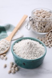 Photo of Bean flour and seeds on white marble table