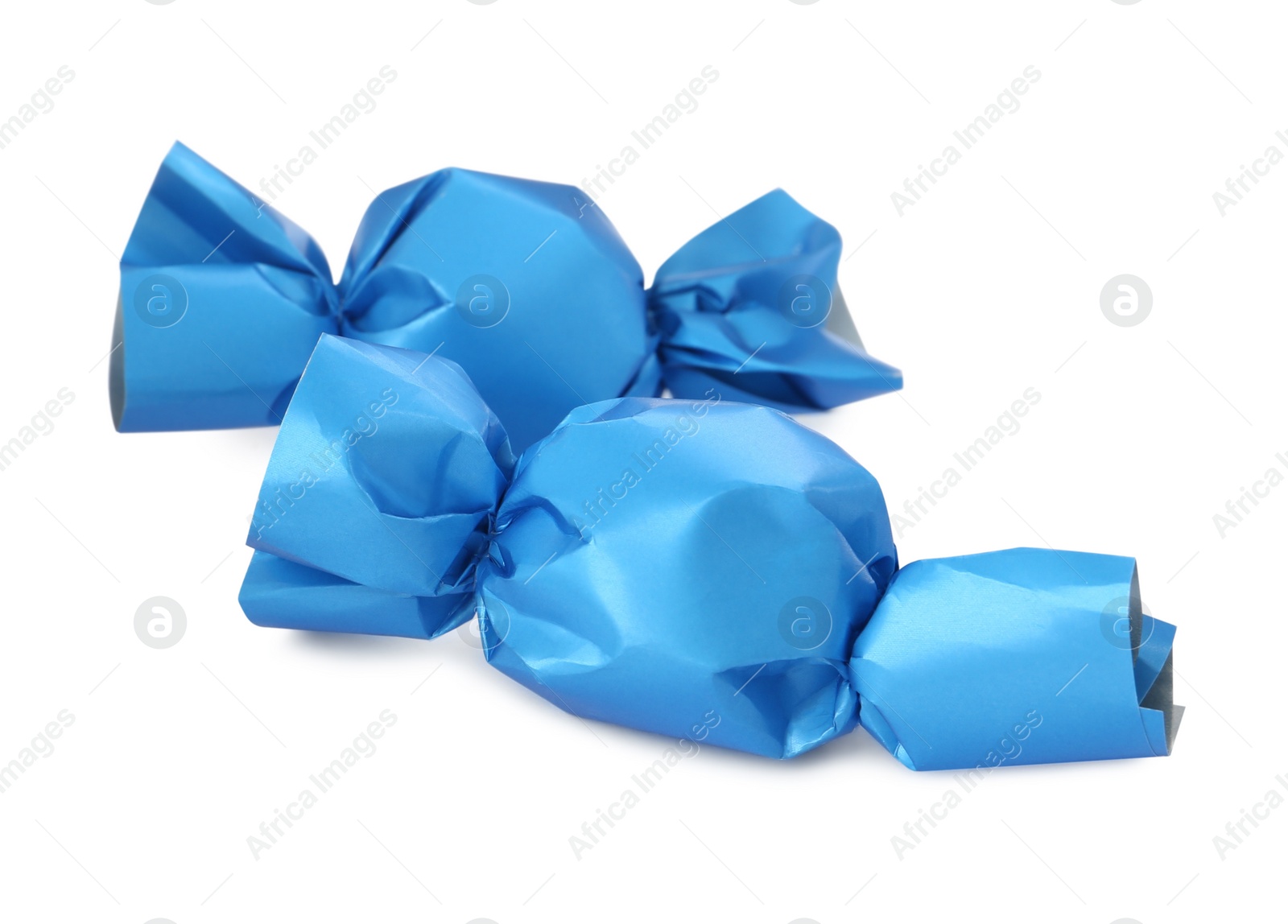 Photo of Delicious candies in light blue wrappers isolated on white