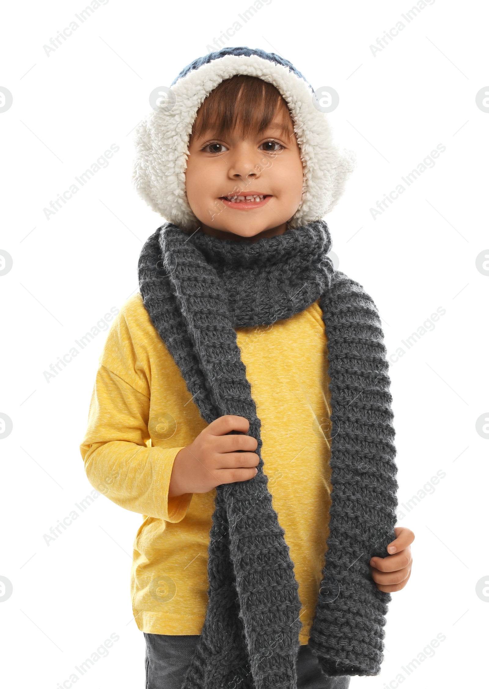 Photo of Cute little boy in warm clothes on white background. Winter vacation