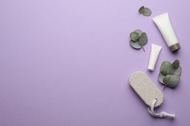 Flat lay composition with pumice stone on violet background. Space for text