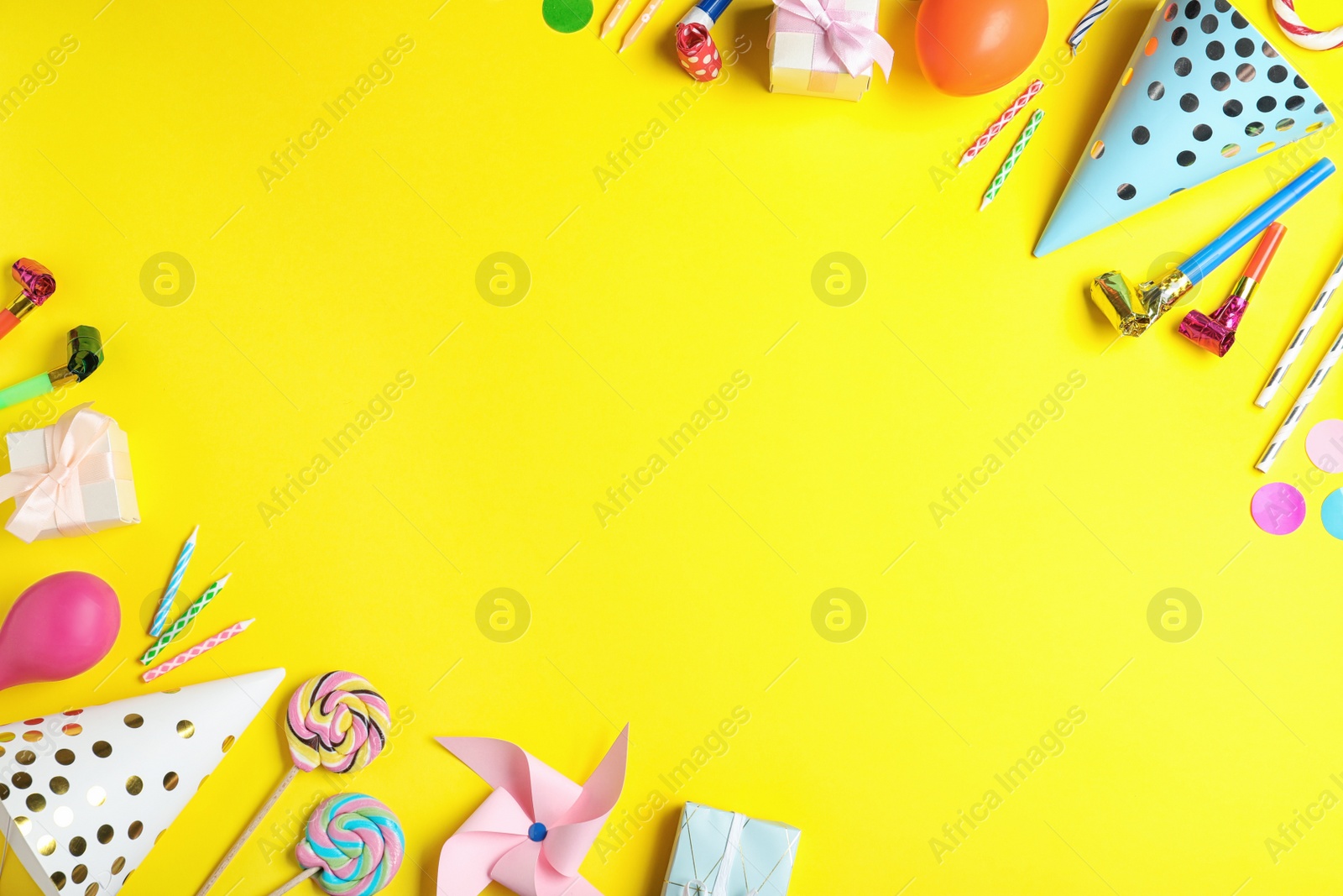 Photo of Flat lay composition with different birthday party items on yellow background, space for text