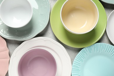 Photo of Beautiful ceramic dishware on light grey table, flat lay