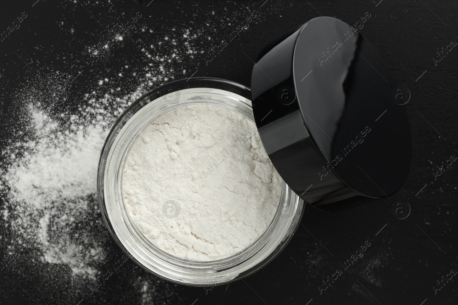 Photo of Rice loose face powder on black background, top view. Makeup product