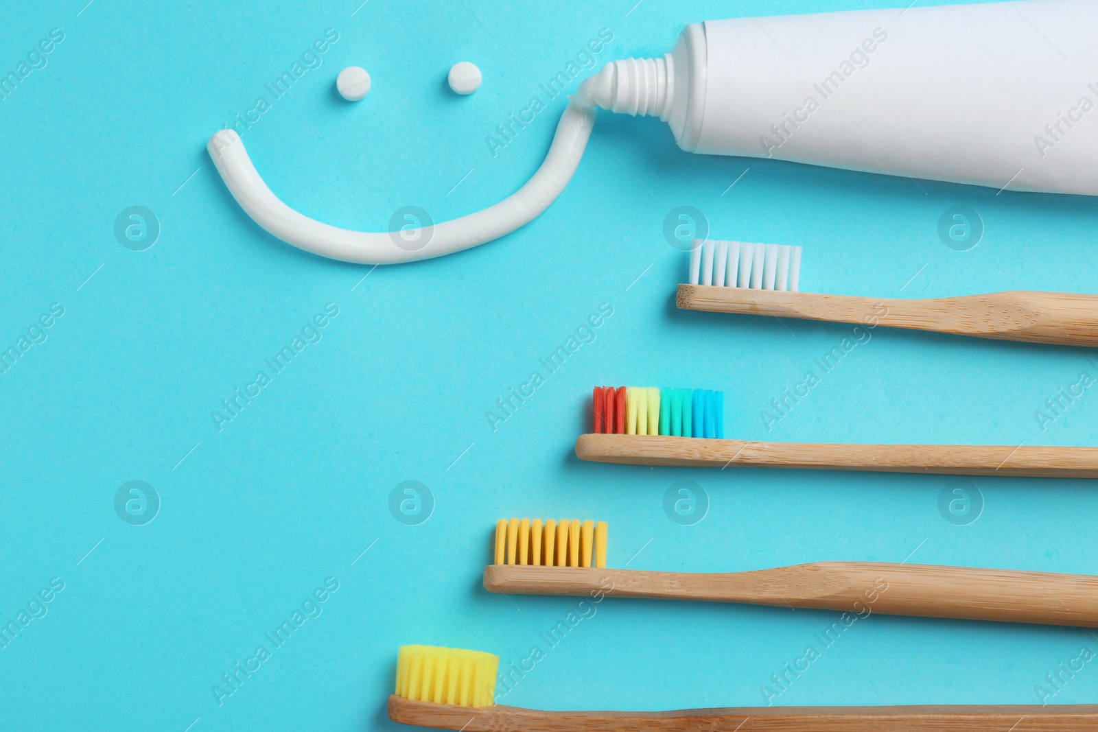 Photo of Flat lay composition with smiling face made of toothpaste on color background