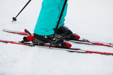 Photo of Skier on slope at resort, closeup. Winter vacation