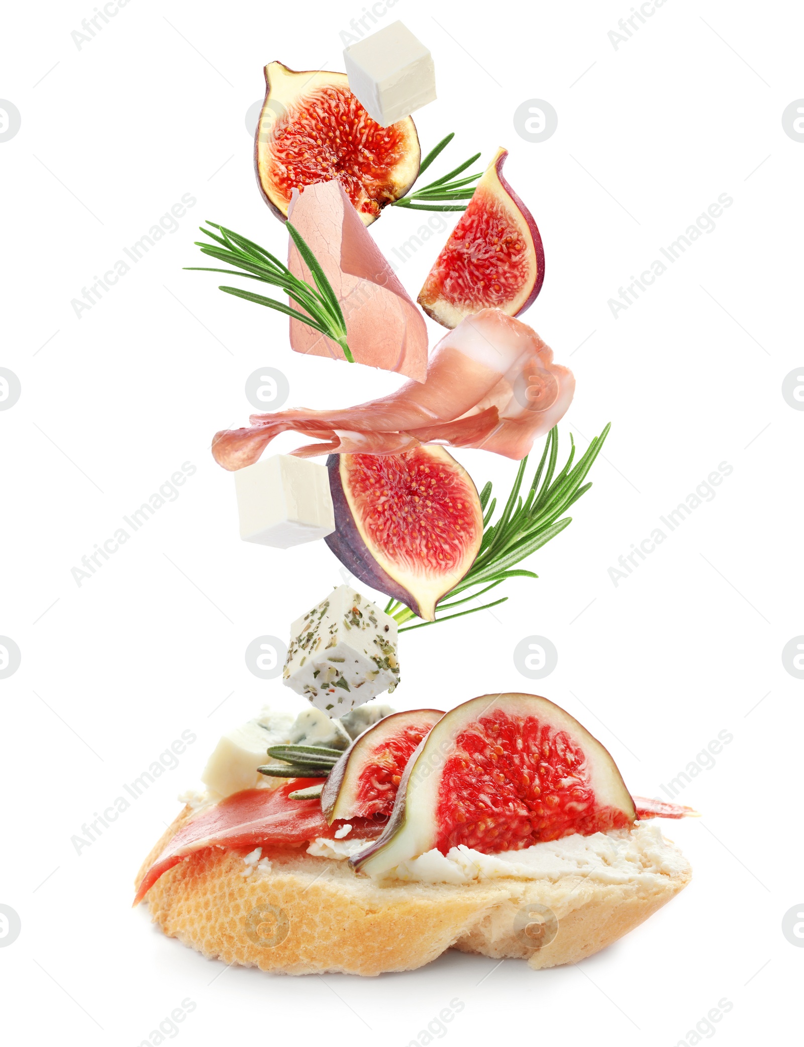 Tasty bruschetta with flying ingredients on white background Image of Tasty bruschetta with flying ingredients on white background