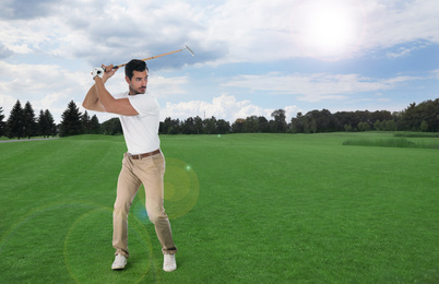 Young man playing golf on course with green grass. Space for design