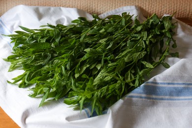 Photo of Heap of beautiful green mint on kitchen towel