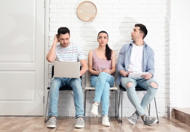 Photo of Group of people waiting for job interview, indoors