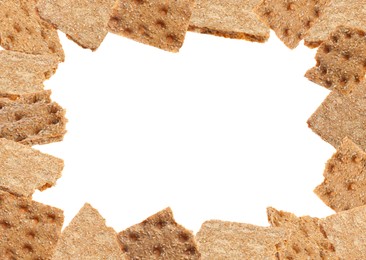 Frame of fresh crunchy rye crispbreads on white background, space for text