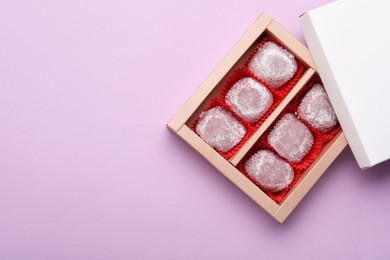 Photo of Box of delicious mochi on light background, top view with space for text. Traditional Japanese dessert