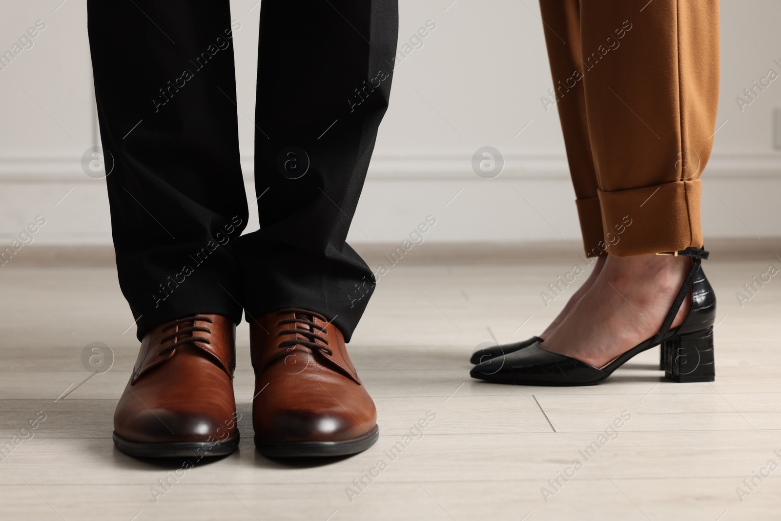 Photo of Businessman and businesswoman in elegant shoes indoors, closeup