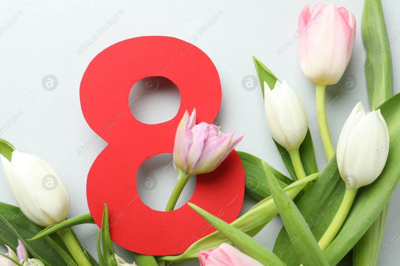 Photo of 8 March card design with tulips on light grey background, flat lay. International Women's Day